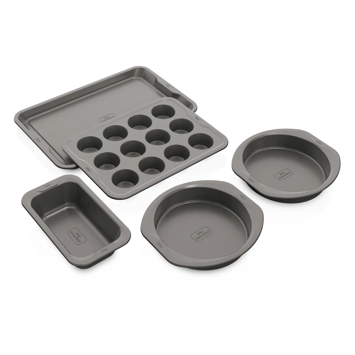 Five gray Ninja NeverStick bakeware pieces: a baking sheet, loaf pan, muffin pan and two round cake pans.